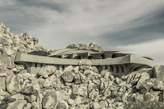 Its cast-concrete roof slabs evoke any number of desert sights—the fronds of a palm, the faces of stones, even the armored plates of an armadillo. 