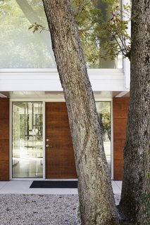 Once Covered in Mold, a Midcentury Gem Outside Chicago Is Reborn - Photo 2 of 15 - On the exterior, Eva chose to cover the existing yellow brick with Prodema wood paneling installed by GFS Architectural Systems, Inc.