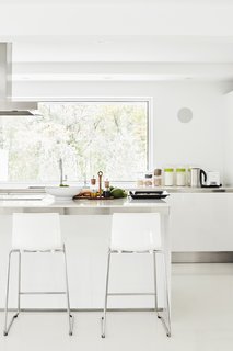 Once Covered in Mold, a Midcentury Gem Outside Chicago Is Reborn - Photo 4 of 15 - For convenience, Eva and restoration architect Victor Drapszo moved the kitchen from the second floor to the first floor, which originally housed a garage, laundry, and guest room. The cabinetry is Gamma by Arclinea, the countertops are Lagoon quartz by Silestone, and the floor is polished concrete.