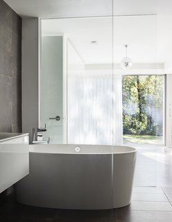 Once Covered in Mold, a Midcentury Gem Outside Chicago Is Reborn - Photo 10 of 15 - The bathtub is by Victoria + Albert and the Terre Ruggine tiles are by Iris Ceramica.