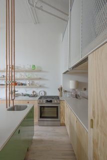 The sink’s copper pipes were rerouted to come down from the ceiling instead of up through the cabinets. Some of the storage units have lacquered MDF faces. 