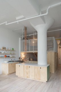 In the kitchen, a quartz Caesarstone countertop hugs the other column.