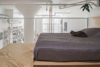 The loft’s four-foot-high rail was fabricated by general contractor Create NYC Contracting, using metal mesh from McNichols. The bed is by Nathaniel Wojtalik.