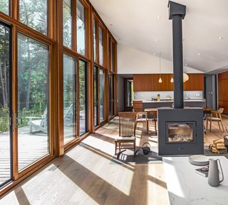Large south-facing windows by Loewen and a high-efficiency Rais X wood-burning stove help to reduce energy demands.