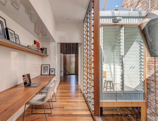 A Sustainable Home Near Sydney Boasts Chicken Coops, Vertical Gardens, and More - Photo 7 of 9 - Upstairs, a breezeway is used as a workspace. Metal and glass louvers by Maxim bring light and air into the master bathroom.