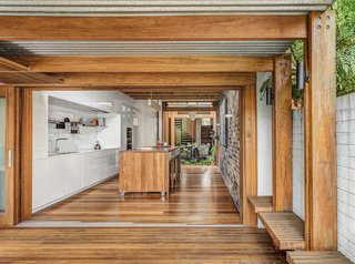 A Sustainable Home Near Sydney Boasts Chicken Coops, Vertical Gardens, and More - Photo 3 of 9 - In the kitchen, an island on casters hides a trio of tables that can be configured in multiple ways both indoors and out. 