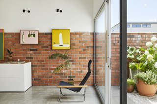 This DIY Home in New Zealand Doubles as a Coffee Spot and Art Gallery - Photo 4 of 16 - Potential buyers can browse his prints, sip espresso, or lounge in the NY chair by Takeshi Nii.