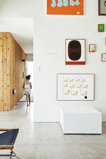 This DIY Home in New Zealand Doubles as a Coffee Spot and Art Gallery - Photo 5 of 16 - Low-cost materials like plaster board, knotty cedar, and polished concrete appear in the gallery as well as in the residence. 