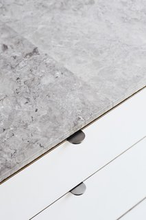 This DIY Home in New Zealand Doubles as a Coffee Spot and Art Gallery - Photo 14 of 16 - <b>Kitchen Countertops: </b>The Jacks saved about $6,500 by skipping counter-sized marble slabs and using one-by-two-foot marble tiles, sealed with silicone. "The counters are thin and highly polished, but the sides have a rough texture," Beer observes.