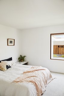 This DIY Home in New Zealand Doubles as a Coffee Spot and Art Gallery - Photo 8 of 16 - Grant painted the master bedroom and the rest of the interior Alabaster by Resene. For big jobs, like framing the walls, they relied on Langsford Construction. 