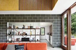 Two Designers Create a Small but Luxe Retreat in the Catskills - Photo 2 of 8 - A vintage shelving unit provides storage and hallway separation. 