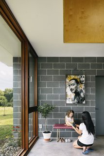 Two Designers Create a Small but Luxe Retreat in the Catskills - Photo 4 of 8 - "God Save Dali," by the artist BNS, hangs above a bench in a corner.