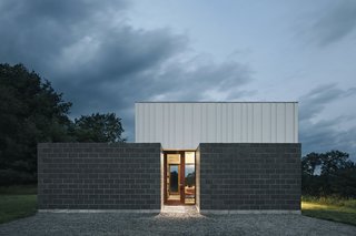 Two Designers Create a Small but Luxe Retreat in the Catskills - Photo 5 of 8 - The house’s concrete and metal are warmed by mahogany-framed windows from Duratherm.