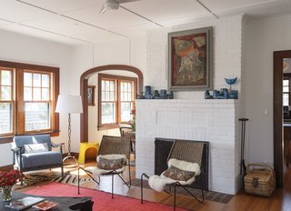 In the living room, a yellow fiberglass stool by Nanna Ditzel sits alongside a French chain-link floor lamp from the 1940s. 