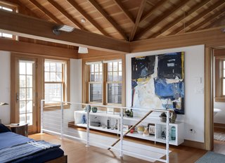 The painting at the top of the stairs is by Barbara Johnson. "Having paintings in the house gives a wonderful sense of fantasy," says Michael. "They enrich the house without competing with the beach."