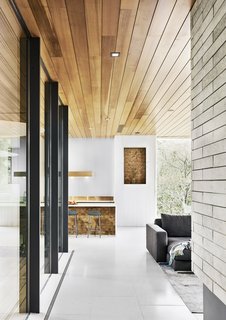 Cover Story: This House in Austin Has a Tree Growing Right Through It - Photo 3 of 10 - Both the niche and the base of the kitchen island are covered in reclaimed end-grain red oak. 