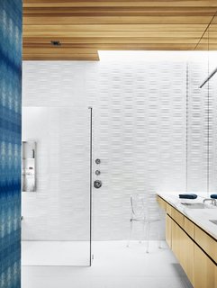 Cover Story: This House in Austin Has a Tree Growing Right Through It - Photo 7 of 10 - The bathroom is covered in Heath tile and indigo Eskayel wallpaper. The Ghost chair is by Philippe Starck. 