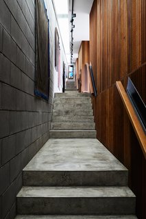 A concrete-block-lined hallway connects the pavilions.