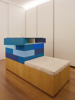 The multi-colored blue cabinets in the closet were designed by the firm.