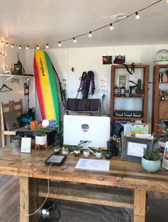 The office is an eclectic mix of plants, camp gear, and rental equipment.