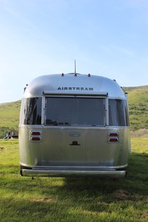 The Globetrotter's aluminum shell catches the evening light. Power stabilizer jacks, an optional power awning, and a window awning package with Sunbrella fabrics help make it a true vehicle of leisure and adventure. 
