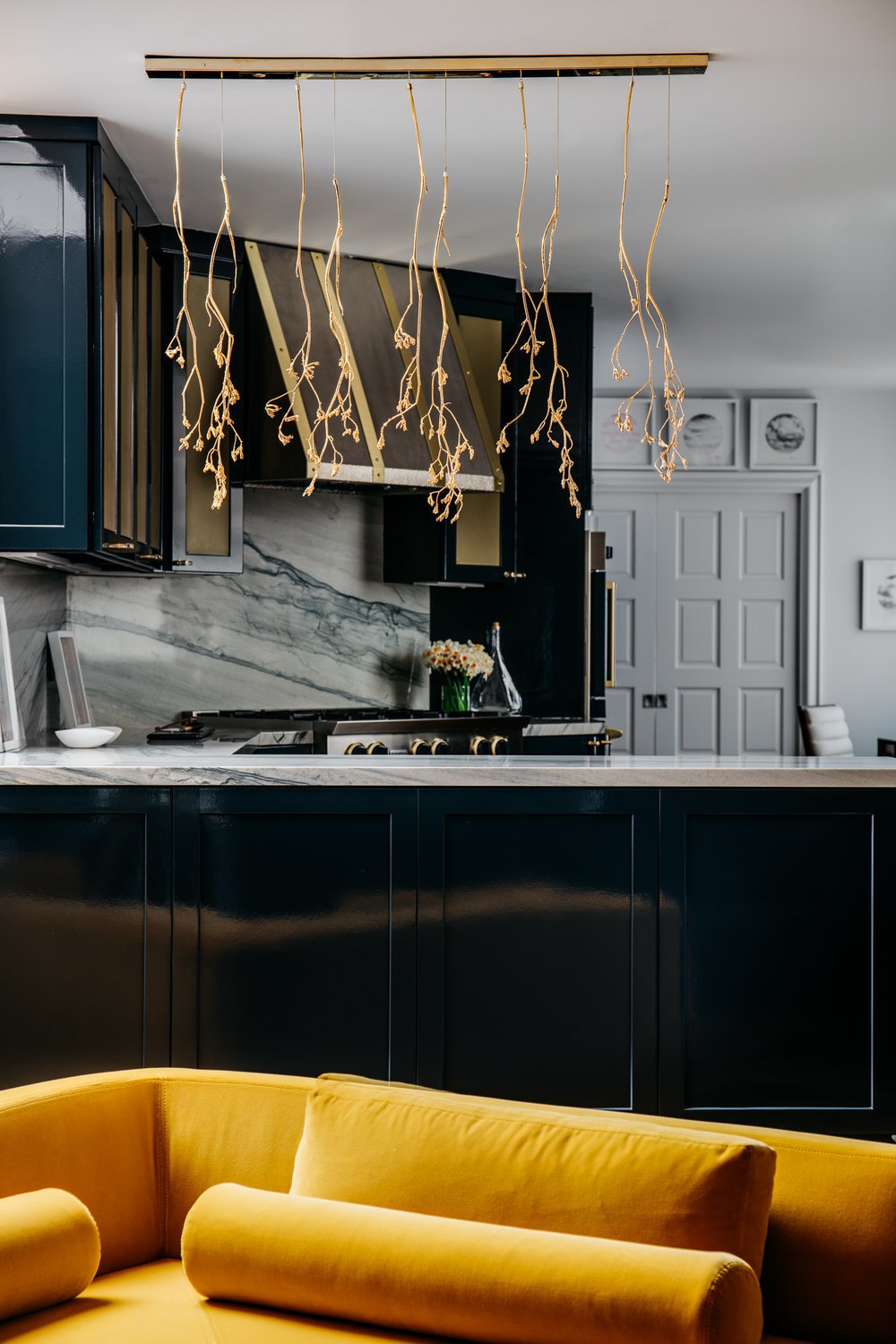 The interior designer of the kitchen and breakfast nook, Ian Stallings, was inspired by the movies. "This house inspired me to think of 1930s screwball romantic comedies," he says. "Something rarely seen in such films are kitchens, so I thought for the back of the house I would turn up the Technicolor and trade it in for contemporary digital cinema. If this room was a movie, it would be Rated G, but this is interior design so I thought it should be Rated IS, for Ian Stallings."