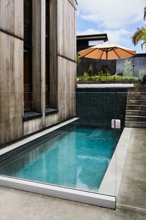 A small pool is positioned at the side of the third pavilion. Stairs lead up to a lounge area and edible garden. "That spot catches the last rays of the sun, so it’s a great place for a gin and tonic at the end of the day," says Rich. "You get this nice layered view all the way down the site and across to Grey Lynn Park."