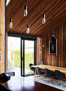 Rich’s wife, Andrea Hotere, is the daughter of New Zealand artist Ralph Hotere. A piece from his 1982 "Mungo" series hangs above a Hawke dining table by Simon James. The chairs are by Charles and Ray Eames for Vitra.