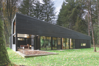 Architect Robert Hutchinson suggested finishing the Western Red Cedar siding of this home with a black semi-transparent stain, and the homeowners were originally skeptical. But they ended up loving it.