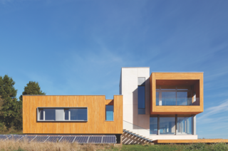 The contemporary, wood and glass home stands out yet nestles right in to the hillside of Newberg, Oregon. 