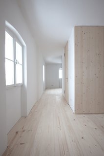In each unit, the architects placed storage and a bathroom in a self-contained wood cube in the middle of the space.