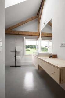 In the loft, the bathroom is located against an exterior wall. The faucet is by Hansa and the towel rack is by Kommod.
