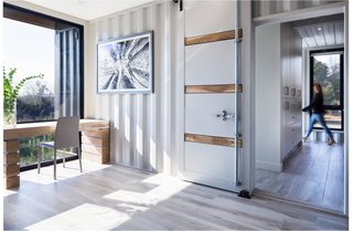 The bedrooms and bathrooms are housed within the 40-by-8-foot boxes, separated by a skylit corridor. 