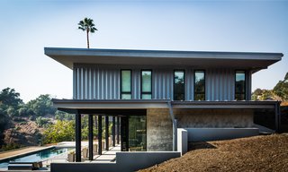 The site-built lower level, erected by Barber Builders, connects to the terrace via corner glass pocket doors. 