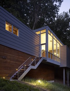 "That middle piece had to be glass," says architect Scott Rappe, explaining that the glowing central pavilion balances the three volumes while maximizing the stunning, wooded views. 