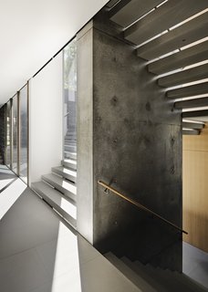 The walls of the staircase are made of poured-in-place smooth concrete.
