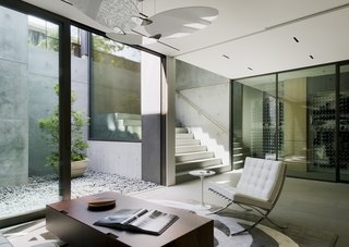 Downstairs, a Barcelona chair by Mies van der Rohe joins a Piuma coffee table by Antonio Citterio for Flexform.