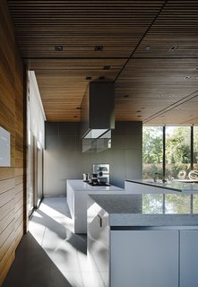 The kitchen countertop is Silestone White Zeus; the bar countertop (foreground) is Opal White marble.