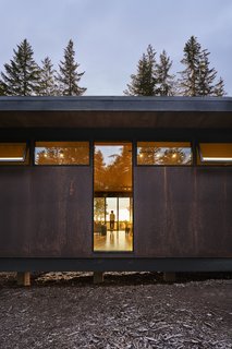 Clerestory windows from Fleetwood are punctuated by a tall strip of glass from Milgard, hinting at the warm, light-filled space within. Alpine Welding did most of the architectural metalwork.