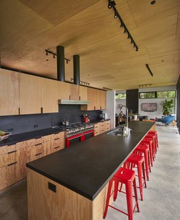 Reminiscent of a shade that Lou’s grandfather, an advertising creative, liked to use in his work, the red of the Fred Meyer barstools matches the Bluestar range. A pair of steel-wrapped vents rise from the fir plywood millwork, built by Schuchart/Dow.