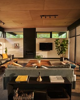 In the living area, a coffee table from Restoration Hardware sits near a vintage bench purchased at Robins Egg Bleu in Winthrop, Washington. 