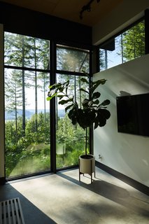 More floor-to-ceiling windows usher the lush landscape inside. 
