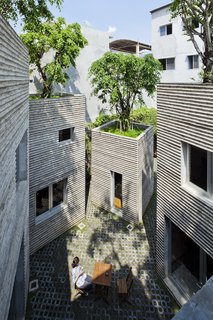 The external walls are made of in-situ concrete with bamboo formwork.
