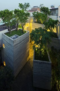 The oasis-like abode stands out amongst the neighboring buildings.