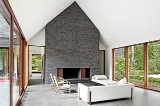 The residence was designed by Baltimore-based architecture firm Ziger/Snead and built by Blackhorse Construction. Its living room features chairs by A. Rudin and a daybed and sofa by Bright Chair.