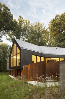 The gabled volumes, angled outward and slightly cantilevered, capture commanding views through giant windows framed in sapele mahogany (below). Marlene recalls the first snowfall at the house. "We all stopped what we were doing—it was like being in a snow globe."
