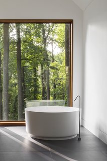 The master bathroom features an Agape tub with a Watermark filler. 
