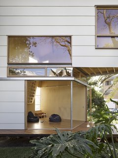 Sliding walls open up the lower level and embrace the surrounding landscape.