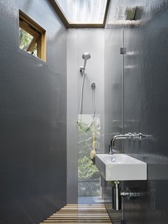 A skylight brings air and light into the bathroom. Because it is outfitted with amenities like plumbing, the tree house can also act as a self-contained dwelling.
