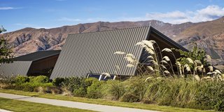 The family has been coming to Wanaka for decades. They bought the hanging metal sculpture in a local shop some 30 years ago. On the street-facing side, the roof folds down almost to the ground to protect the owners’ privacy. 